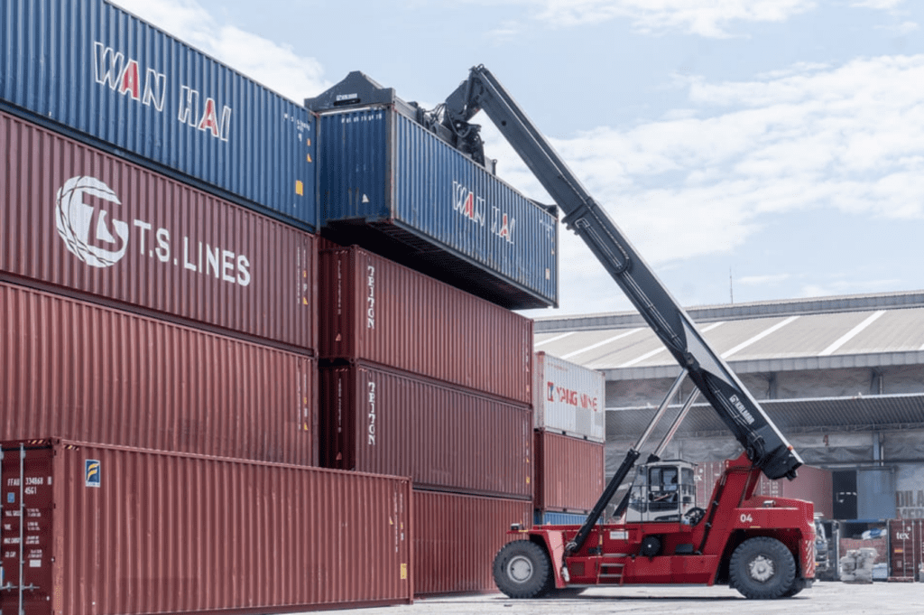 Crane lifting shipping container for transloading services in Memphis, TN.