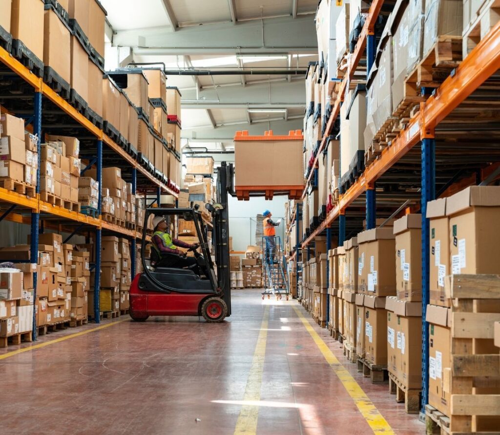 Secure Long Beach warehouse with forklifts, organized aisles, and 24/7 monitored storage operations.