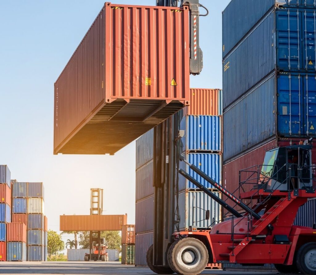 Crane lifting a container at Port Tampa Bay, representing OLIMP’s drayage services and import/export transloading solutions.