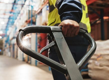 Logistics staff coordinating warehousing and transportation services inside a large Arkansas distribution warehouse.