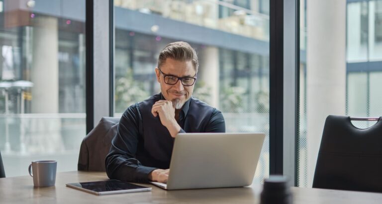 A logistics manager analyzing warehouse options on a laptop, comparing locations, pricing, and facility features to optimize supply chain operations.