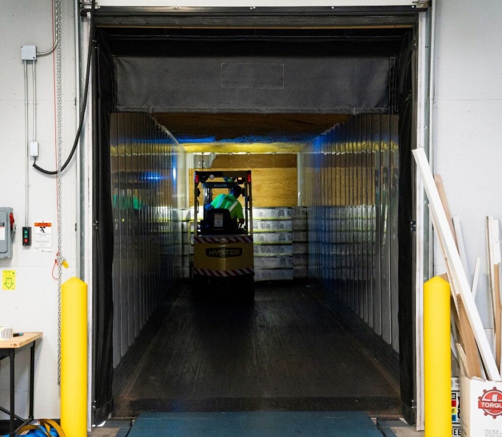 Cross-dock operations in Fort Worth transferring freight between inbound and outbound trucks