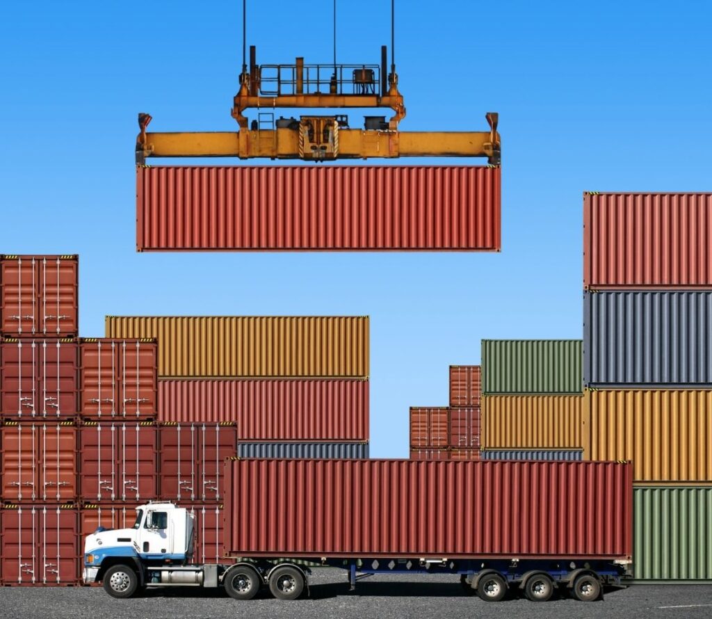cargo being transferred between truck and container for transport