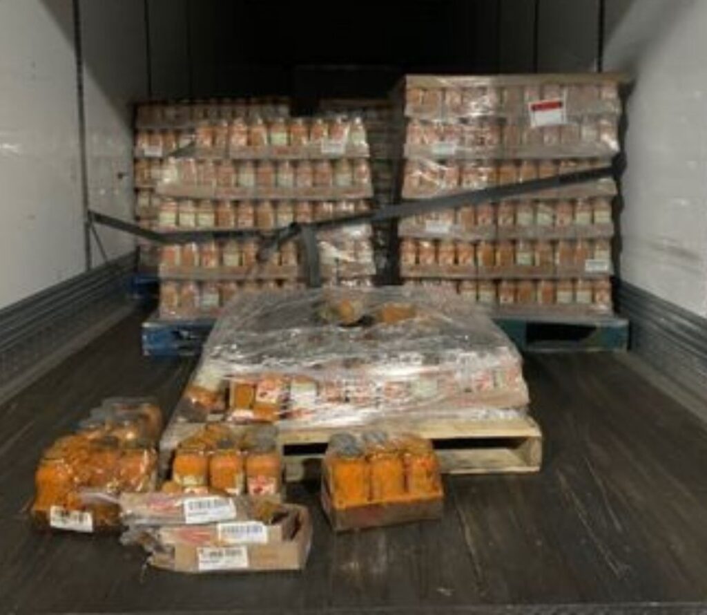 Workers carefully restacking pallets and preparing shipments for last-mile delivery at OLIMP Warehousing in Stockton.