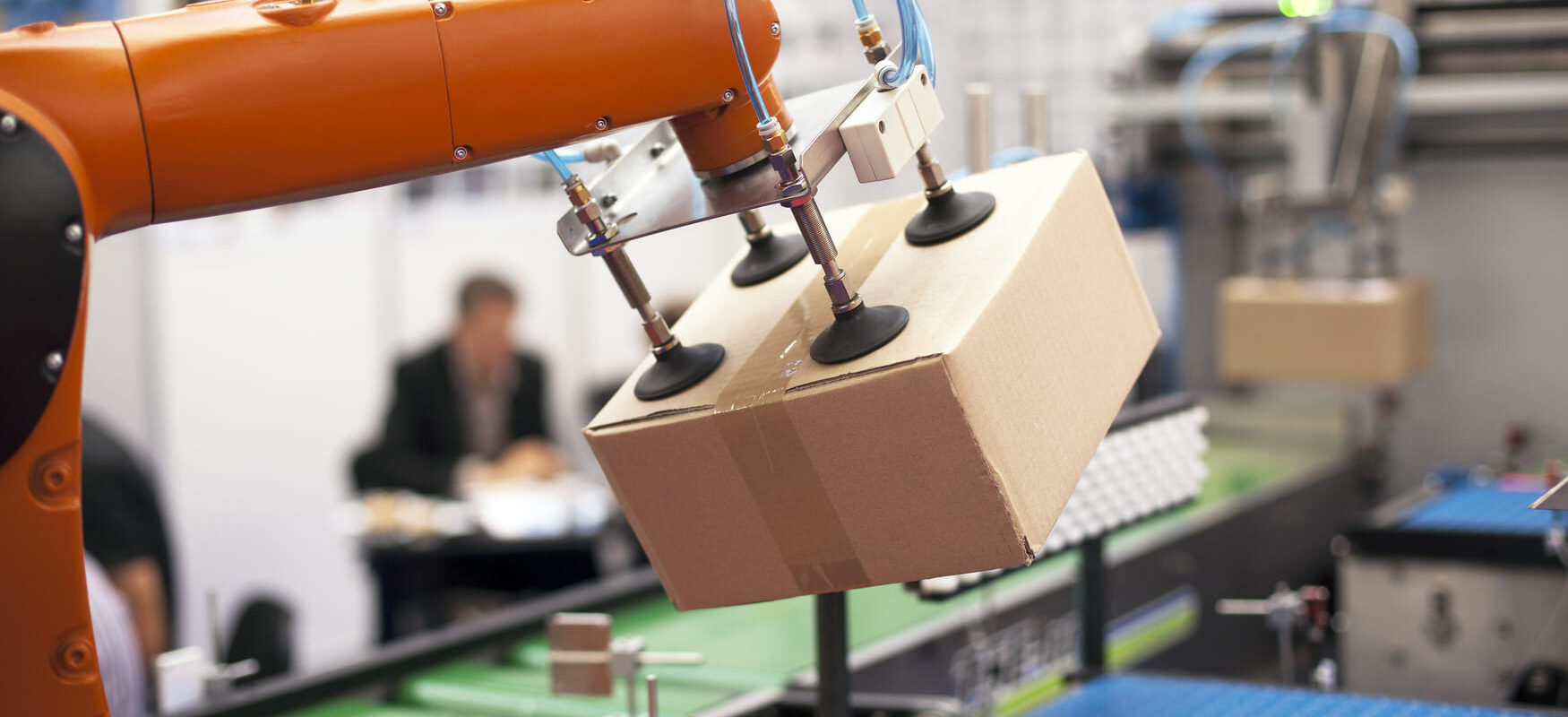 Automated warehouse picking system with robots and workers using pick-to-light and barcode scanning tools to improve warehouse picking speed and accuracy.