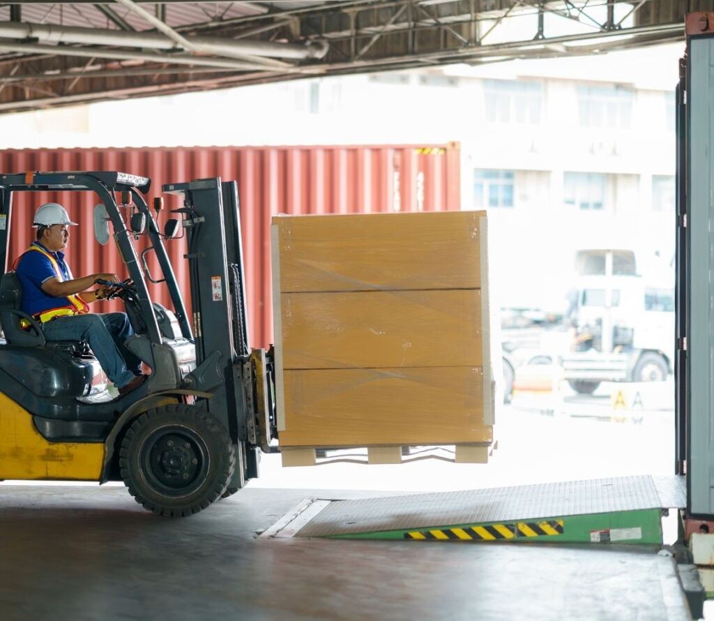 cross docking warehouse in Chino CA with trucks loading and unloading at dock doors