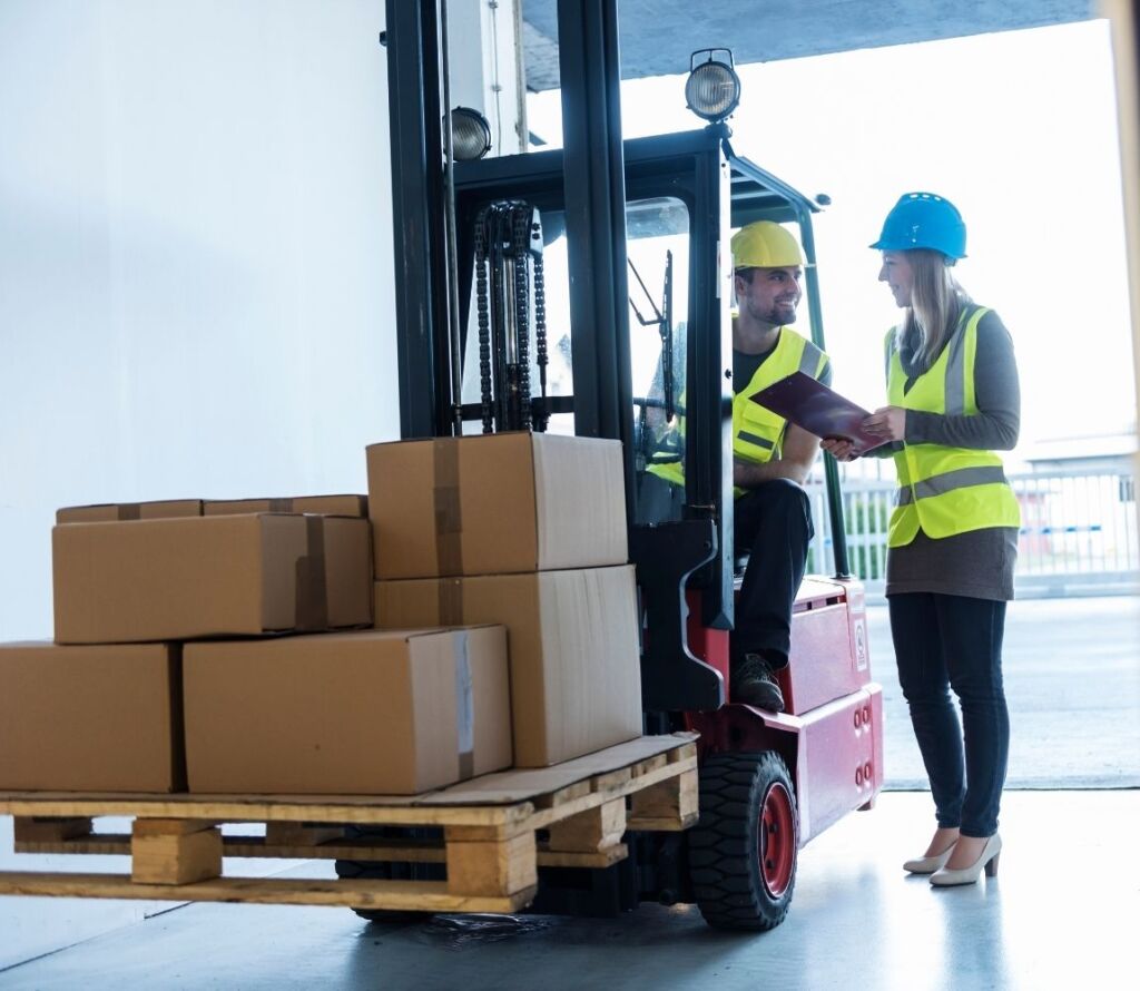 Cross docking operations in New Braunfels TX with trucks unloading and loading freight at dock doors.